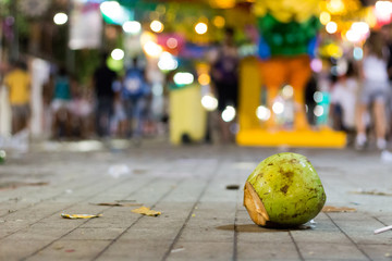 A coconut on the street after carnival celebration, Brazil.