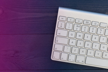 Wireless computer keyboard on night office desk with copy space