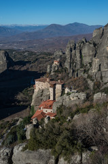 Fototapeta na wymiar The Monastery of Rousanou or St. Barbara Monastery and the Monastery of St. Nicholas at Meteora. Meteora is one of the largest built complexes of Eastern Orthodox monasteries in Greece.