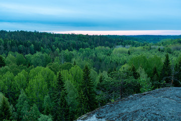 Fototapeta na wymiar Morning over the spring forest, View from a high rock