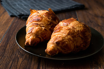 Freshly Baked Croissants on Wooden Surface.