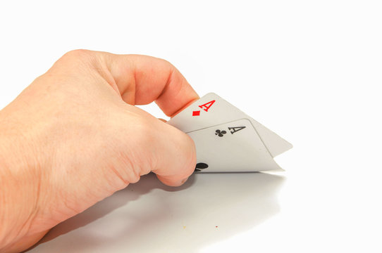 Hand with two cards aces. on a white background.
