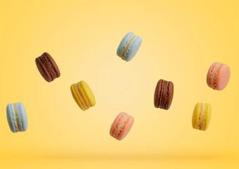 Colorful macarons cakes. Small French cakes. Sweet and colorful french macaroons falling or flying in motion.