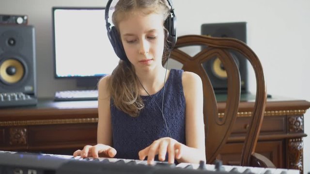 Little girl recording a song in home music studio.