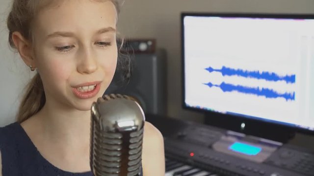 Little girl singing a song in home recording studio.