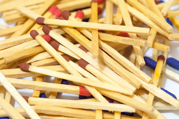 match sticks spread on white paper abstract concept
