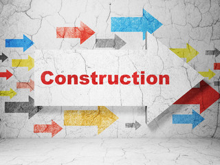 Construction concept:  arrow with Construction on grunge textured concrete wall background, 3D rendering