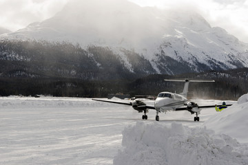 A private jet landing in the airport of St moritz Switzerland in the alps in winter