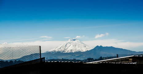 Beautiful landscape of Cotopaxi volcano in the horizont covered with snow, picture taken from Quito, Ecuador