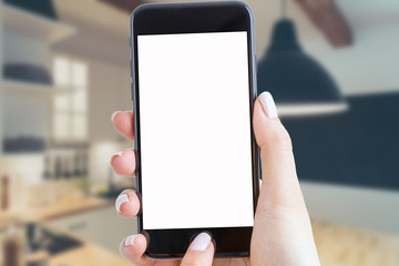 smartphone holds a hand in the kitchen