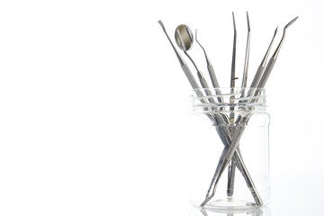 Set of metal dentist's dental medical equipment tools isolated on white background with copy space, close-up