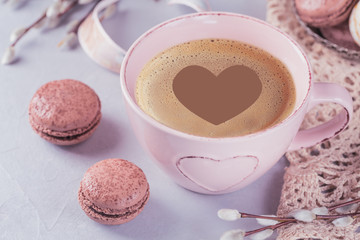 Pink coffee mug with sweet pastel french macaroons and pussy willow