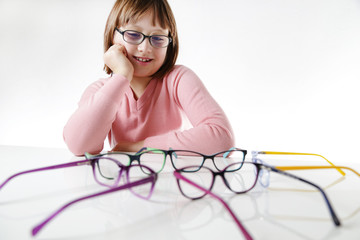 Dziewczynka patrzy na okulary dziecięce  © doroguzenda