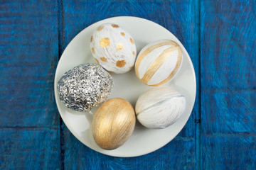 Happy Easter. Painted eggs on wooden table. Top view. Copy space for text.