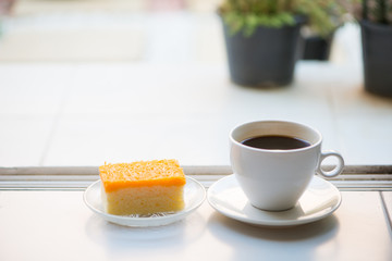 A cup of coffee and golden threads cake