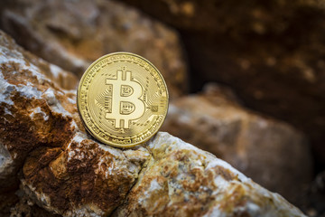 Golden bitcoin as main digital currency worldwide presented on the stone.