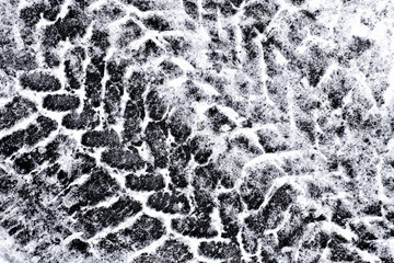 Tyre mark on snow asphalt road winter background.