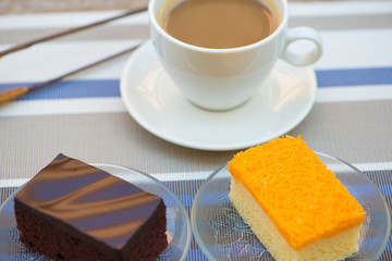 A cup of coffee and Chocolate and golden threads cake