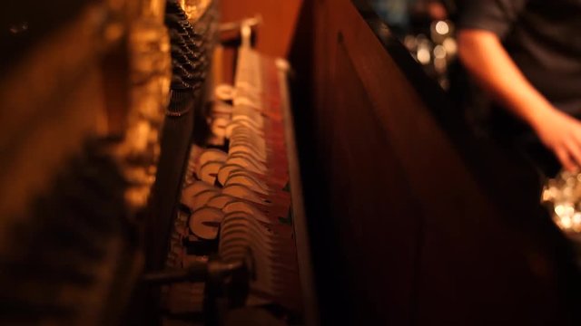 Hammers inside piano rhythmically beating during live concert.