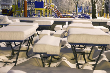 Snow-covered attractions in the old park