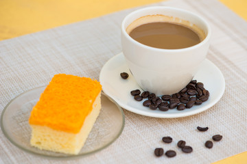 A cup of coffee and golden threads cake