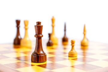 Wooden chess pieces on a chessboard