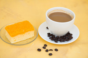 A cup of coffee and golden threads cake