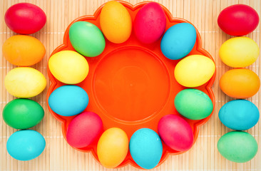 Easter concept painted eggs on wooden table in plate for holiday with place for text pattern with frame