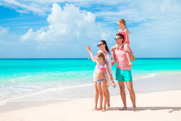 Happy beautiful family on white beach