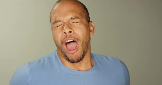 4K Close up portrait exhausted mixed race man doing a big yawn to camera. Slow motion.