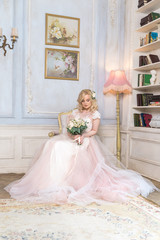 Fototapeta premium girl in white dress sitting in a vintage chair