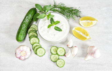 Obraz na płótnie Canvas Tzatziki sauce ingredients Yoghurt herbs vegetables food