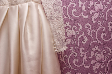 wedding dress of the bride on pink background