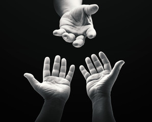 International human rights day concept: Black and white child reaching two hand to God on dark room background