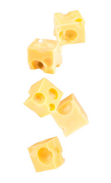 Falling cubes of cheese isolated on white