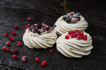 Pavlova cakes with cream and fresh summer berries - 192381949