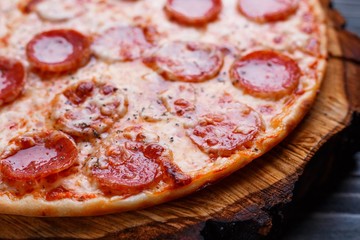 Delicious yummy pizza with pepperoni and cheese, close up. Italian food