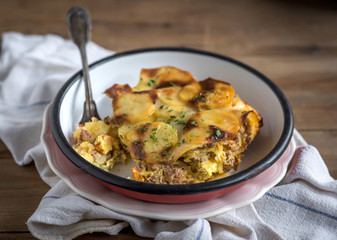 Prepred traditional Greek moussaka with potatoes served in the plate,selective focus