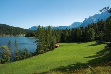 Fototapeta na wymiar Alpine view with Lautersee lake and green meadow, Germany