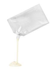 Mayonnaise flows out of the package on white background