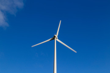 Fototapeta premium Upper part of a wind turbine against blue sky