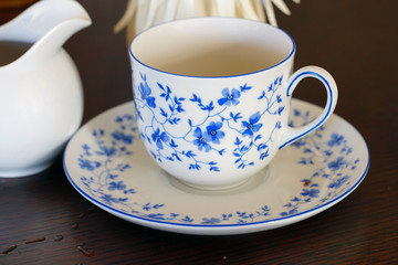 Fototapeta premium A china tea cup and saucer with a blue and white flower pattern