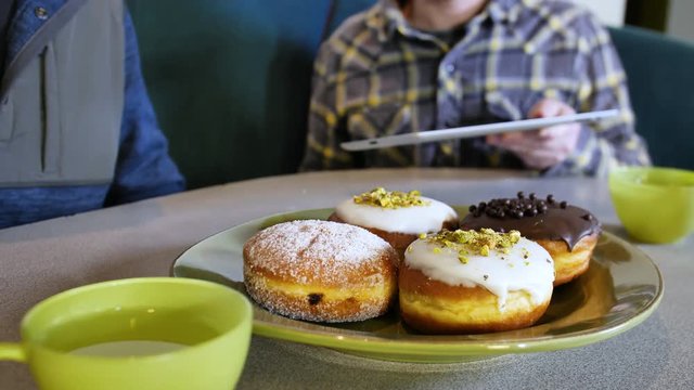 Paczki Donut Pastry Breakfast Business Meeting Man Scrolling Computer Tablet Screen