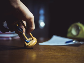 close up of hourglass in the person's hand on the table clock