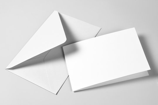 Blank card and envelope over grey background