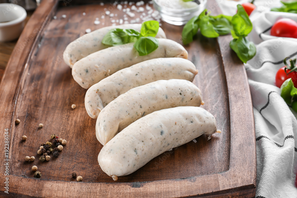 Wall mural Delicious white sausages on wooden board