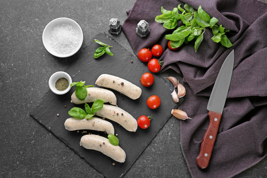 Delicious white sausages on slate plate