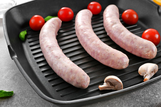 Grill pan with delicious sausages, closeup