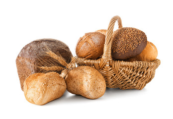 Composition with wicker basket and different bread isolated on white