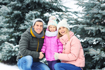 Portrait of happy family in winter park